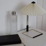 Water Tracking Bottle and Better Every Day Jouranal on white table next to lamp