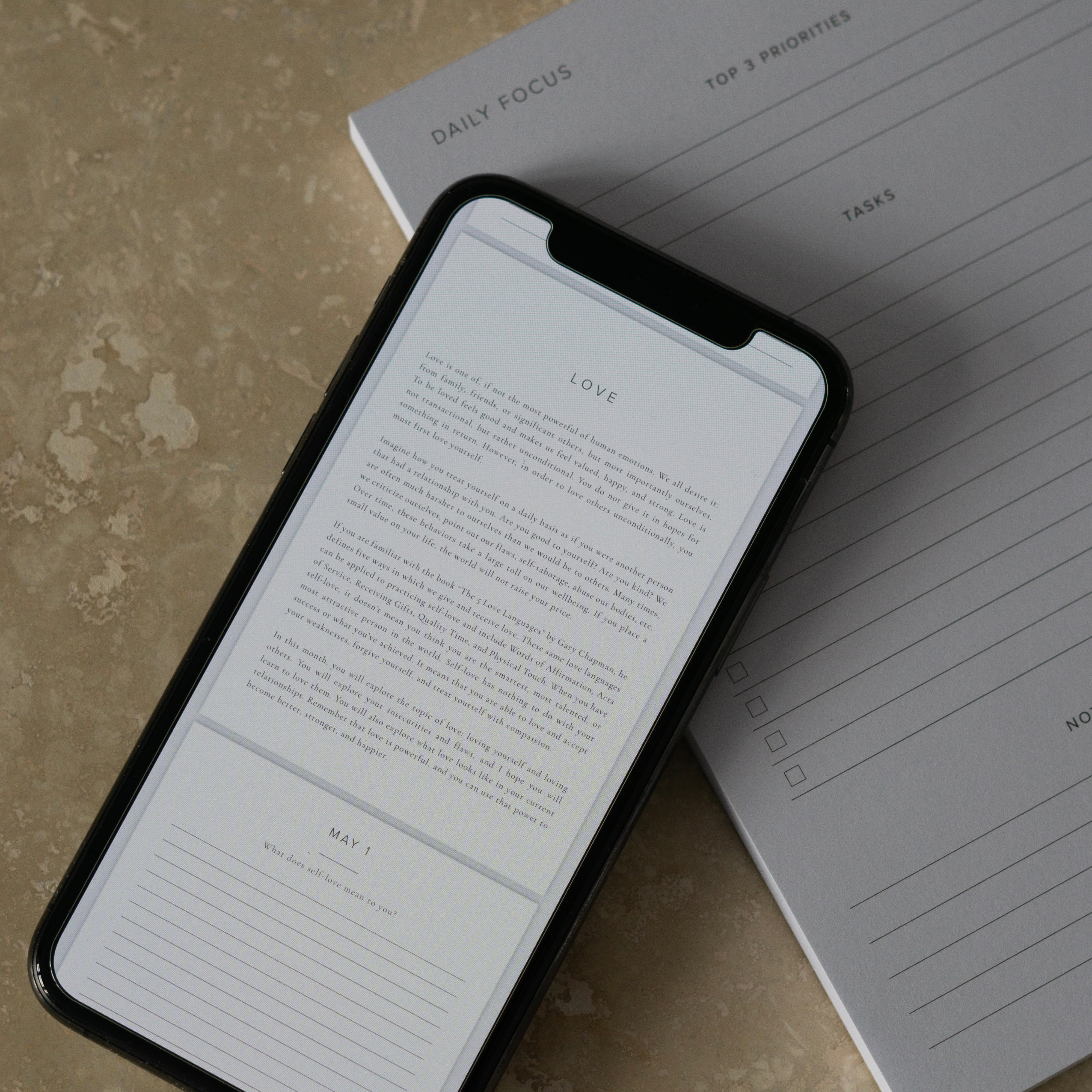 Love section of Better Every Day Journal displaying on iphone on top of Daily Focus Notepad
