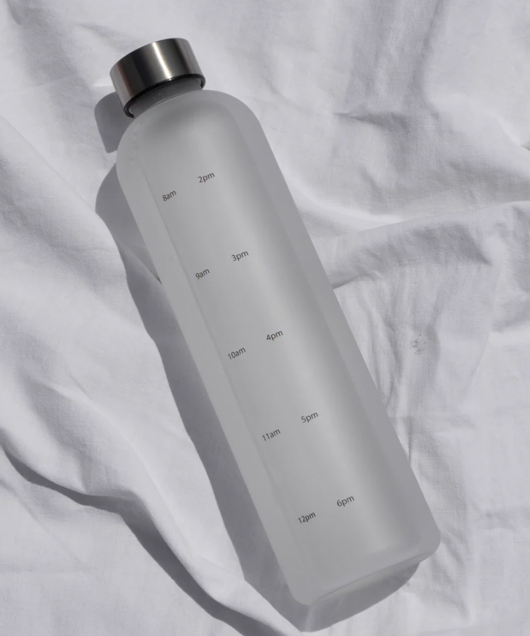Inside Then Out's Water Tracking water bottle placed on its side on a white sheet