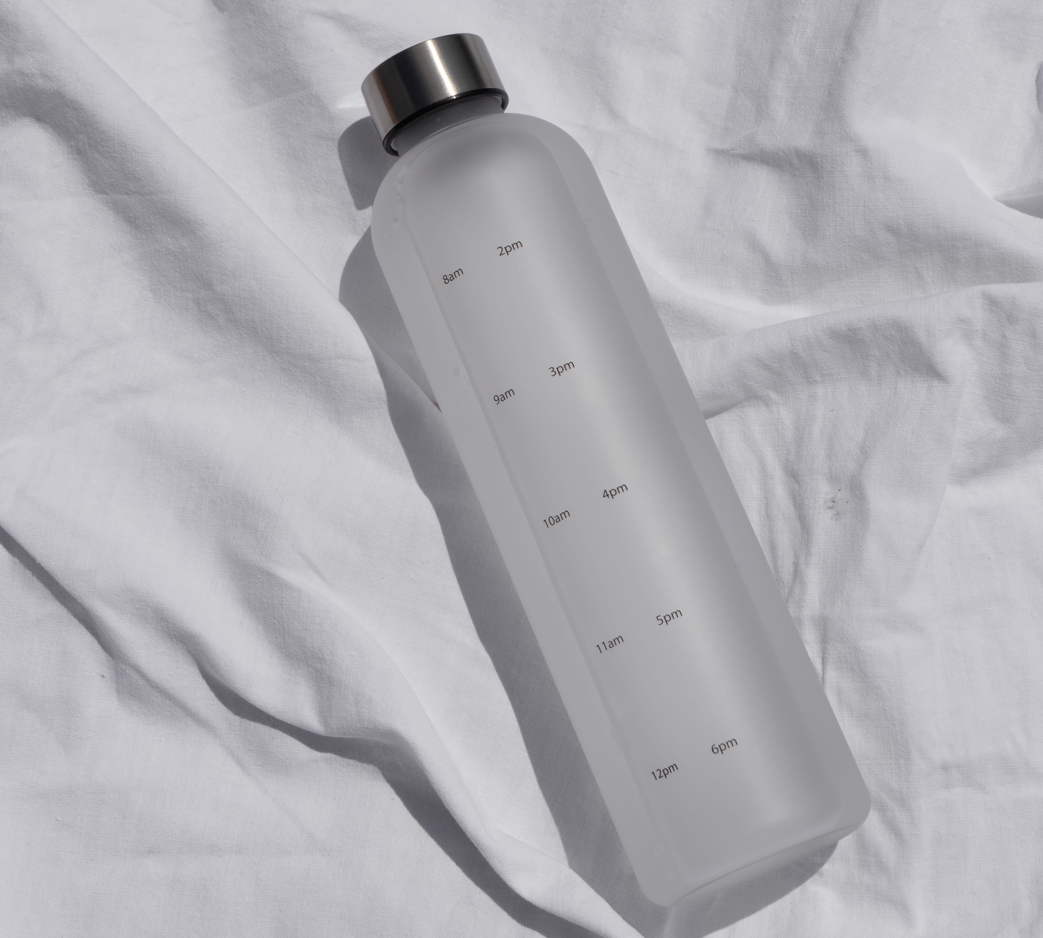 Water tracking bottle on white sheet